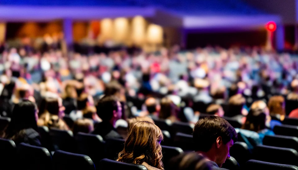 Audience seated in a large conference hall